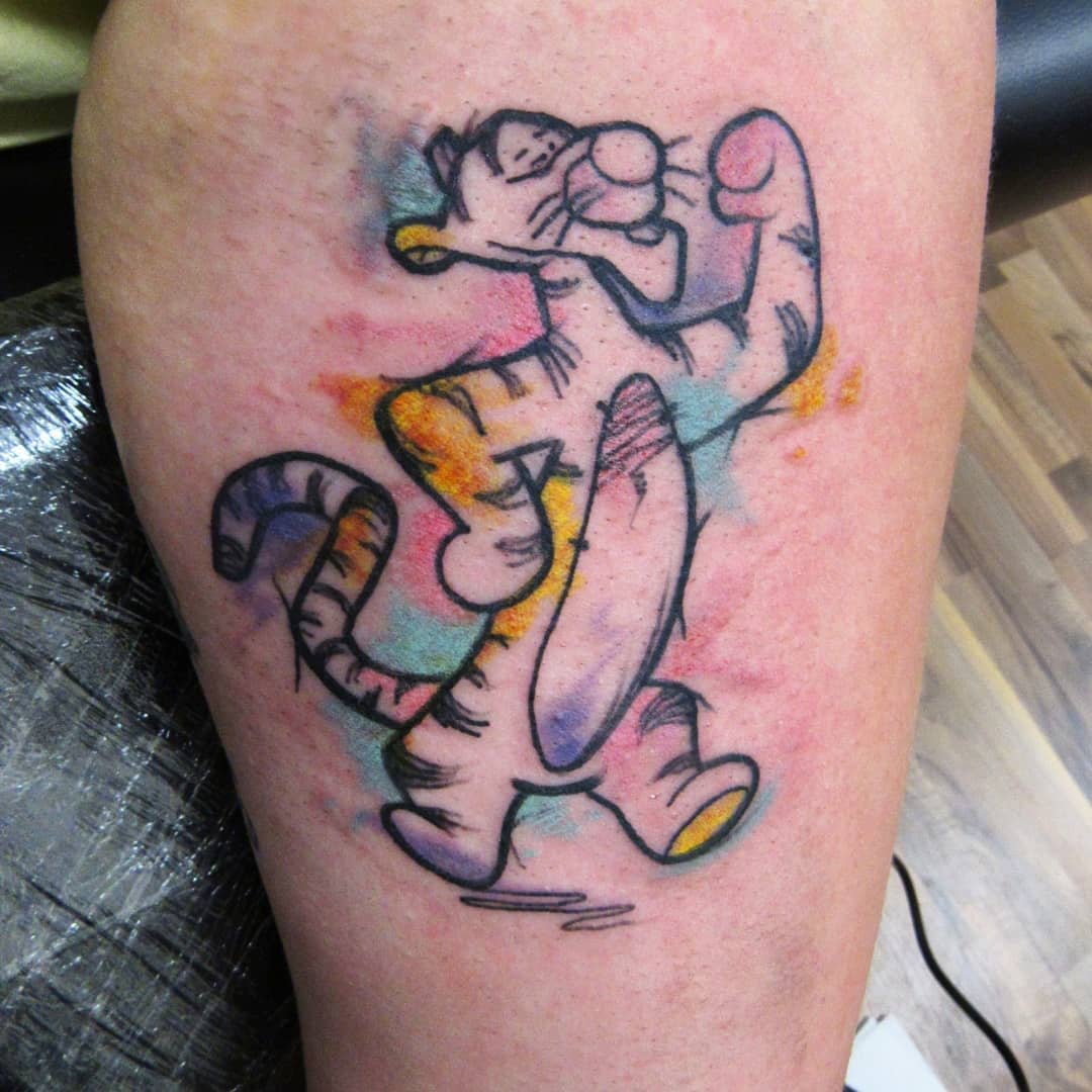 Colorful tattoo of Tigger from Winnie the Pooh on an arm